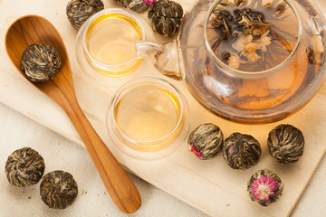 exotic green tea glass teapot with floral blooming tea ball