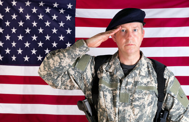 Veteran solider saluting with USA flag in background while armed