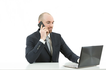 Business man sitting at the office and talking on the phone