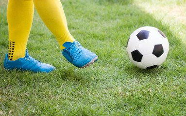 Fototapeta na wymiar Athlete Kicking a soccer ball on field.