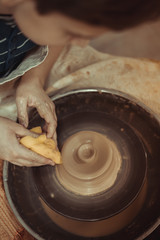 child working hands with clay