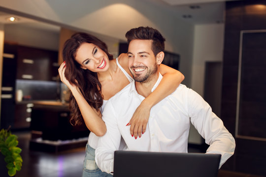 Successful young couple laughing indoor