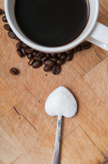 Coffee cup with sugar on a heart shaped spoon