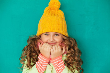 eautiful little lady wearing yellow woolen cap and scarf