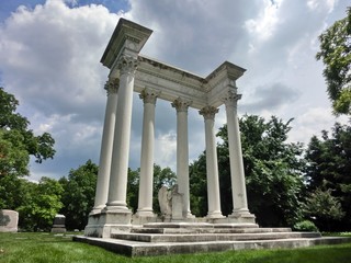 Majestic tomb with Roman style columns and concrete angel