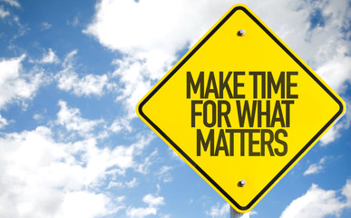 Make Time For What Matters sign with sky background