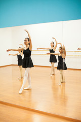 Dance instructor teaching little girls