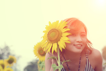 Obraz na płótnie Canvas Beautiful sexy woman with sunflower in sunflower fields smile at
