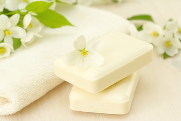 Fototapeta na wymiar SPA setting. Jasmin soap and flowers and on wooden table