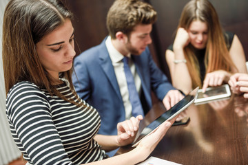 Business team using tablet computer to work with financial data