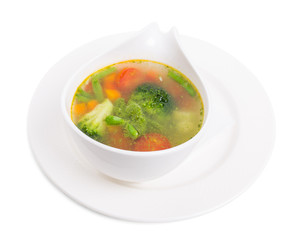 Bowl of minestrone soup with pesto.