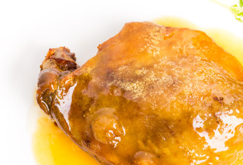 Duck leg confit with yellow sauce.