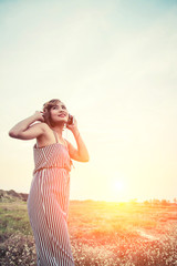 Beautiful sexy woman listening music from smartphone in the flow