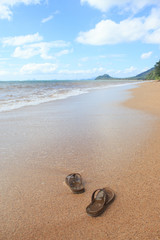 sandals on sand beach in summer sea in vacation and relax time