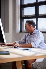 Smiling man working on computer