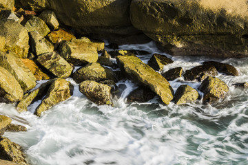 Fototapeta premium Soft, crashing waves in the rocky coves of the Sunset Cliffs in San Diego, California