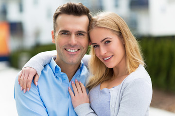 Fototapeta premium Young couple smiling outdoors