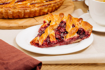 Homemade cherry pie on rustic background
