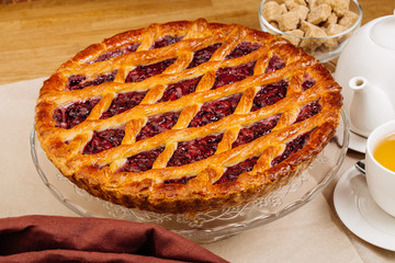 Homemade cherry pie on rustic background