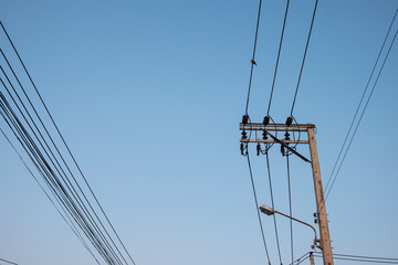 Fototapeta premium electric pole power lines and wires with blue sky