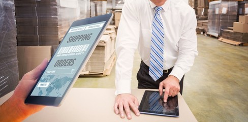 Composite image of man using tablet pc