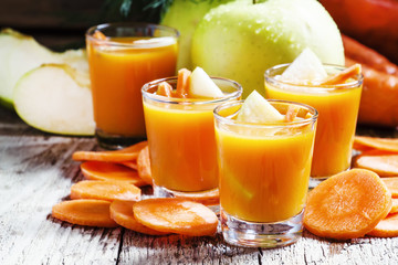 Apple-carrot fresh smoothies, vintage wooden background, selecti