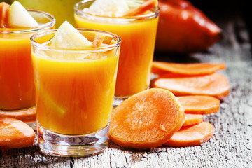 Apple-carrot fresh smoothies, vintage wooden background, selecti