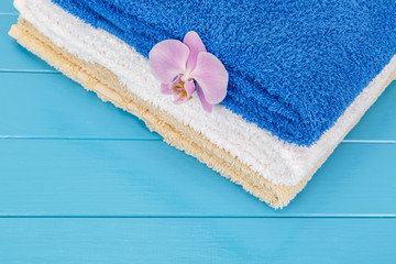 View of  stack of towels on a blue wooden background.