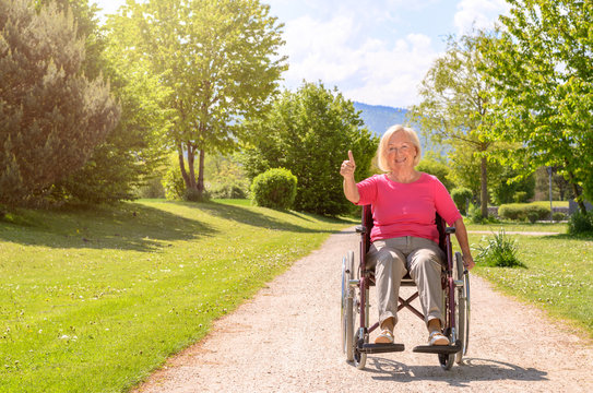 White haired elderly woman seated in wheel chair