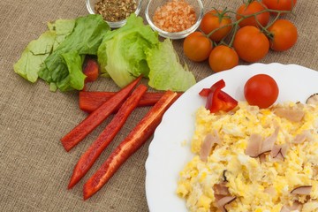 Fresh scrambled eggs with bacon and vegetables. Domestic eggs for breakfast. Breakfast athletes. Preparing eggs. Protein diet. Eggs in different kinds of preparations.
