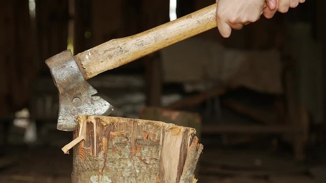 Axe in a stump.Slow motion.