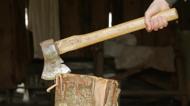 Old and rusty axe in a stump.
