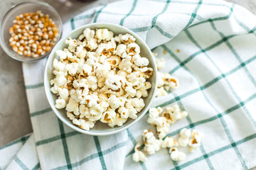 bowl of salty popcorn and soda