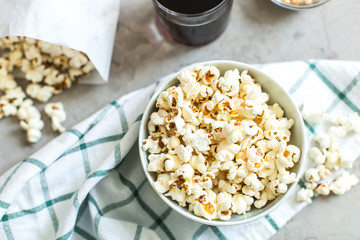 bowl of salty popcorn and soda