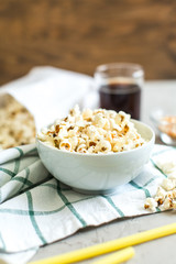 bowl of salty popcorn and soda