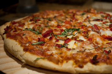 Spicy Sicilian chicken pizza made in a tradional wood oven.