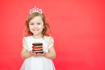 Blond hair little girl holding cake on red background