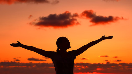 Woman's silhouette on sunset light