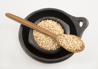 Grain oats in bowl and wooden spoon.