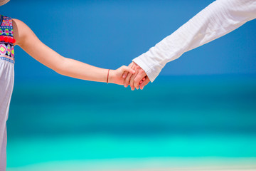 Close up hands of father and daughter background blue sky