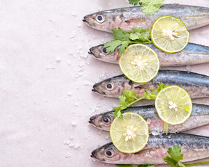 sardines with lemon slices, sea salt and parsley on tracing paper