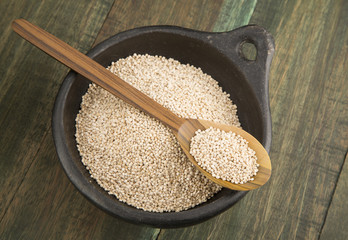 Quinoa in bowl and wooden spoon.