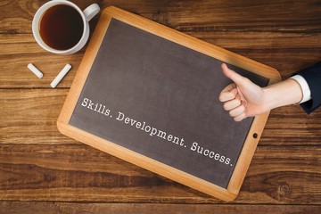 Composite image of hand showing thumbs up