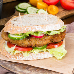sandwich with fried meat and vegetables