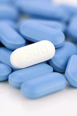 White caplet on blue caplets background.