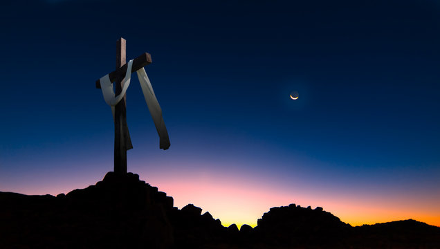 Christian cross over dark sunset background panoramic view