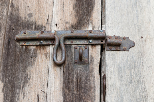 close brown door and rusty lock closeup