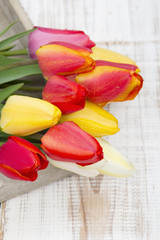 tulip bouquet on white wooden background