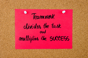 Red paper note with handwritten text on cork board