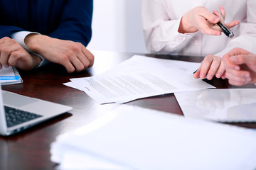 Business women giving a pen to business man for contract signing